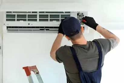 Technician performing AC diagnosis and repair